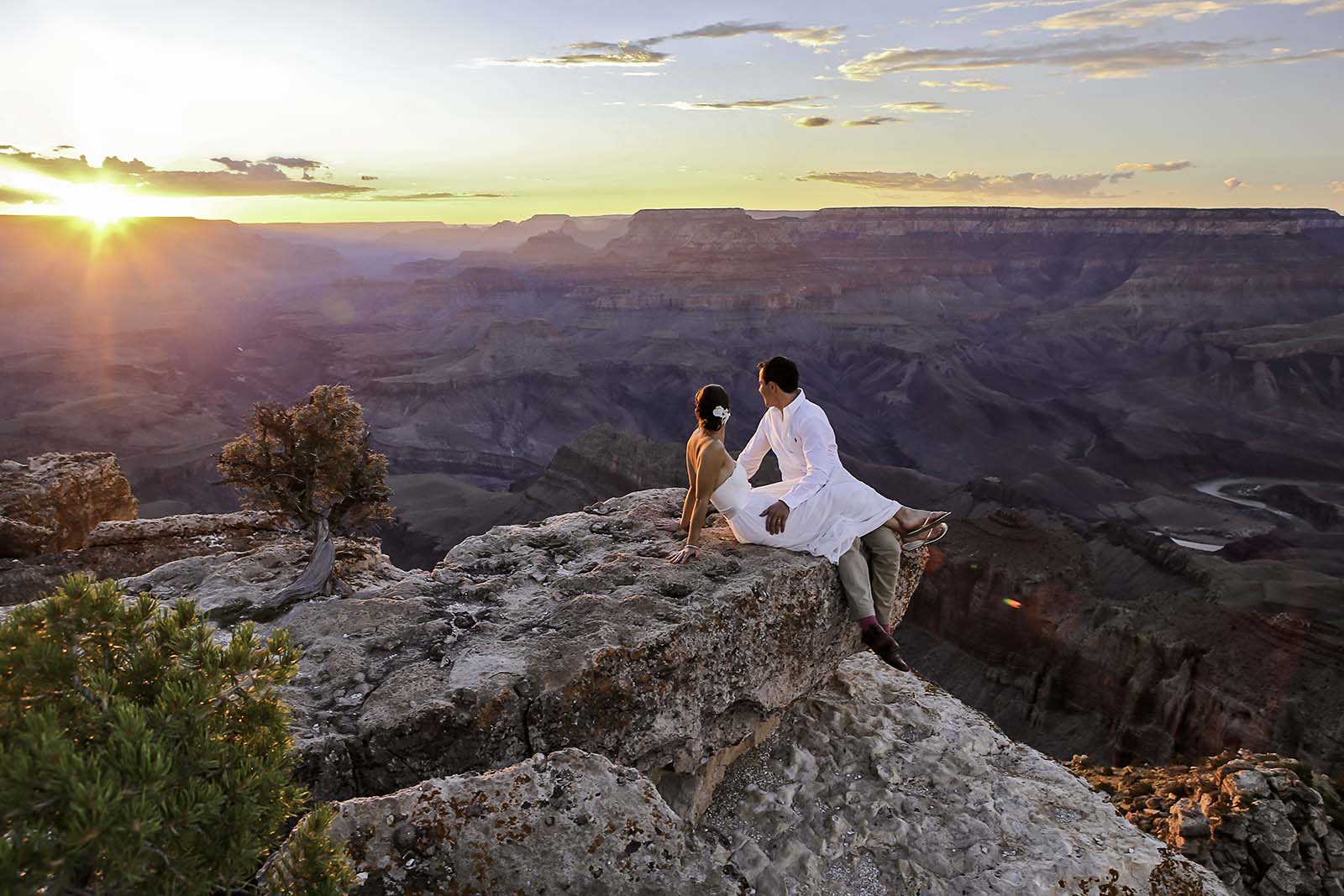 A young couple enjoying the sunset after eloping at Lipan Point in the Grand Canyon